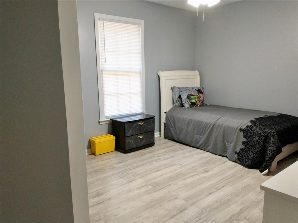 766 Country Club Road Newnan, GA 30263 - Photo 18 of 34 Bedroom with light wood-style flooring and baseboards