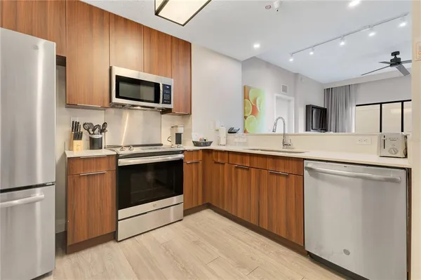 a kitchen with a sink a microwave and refrigerator