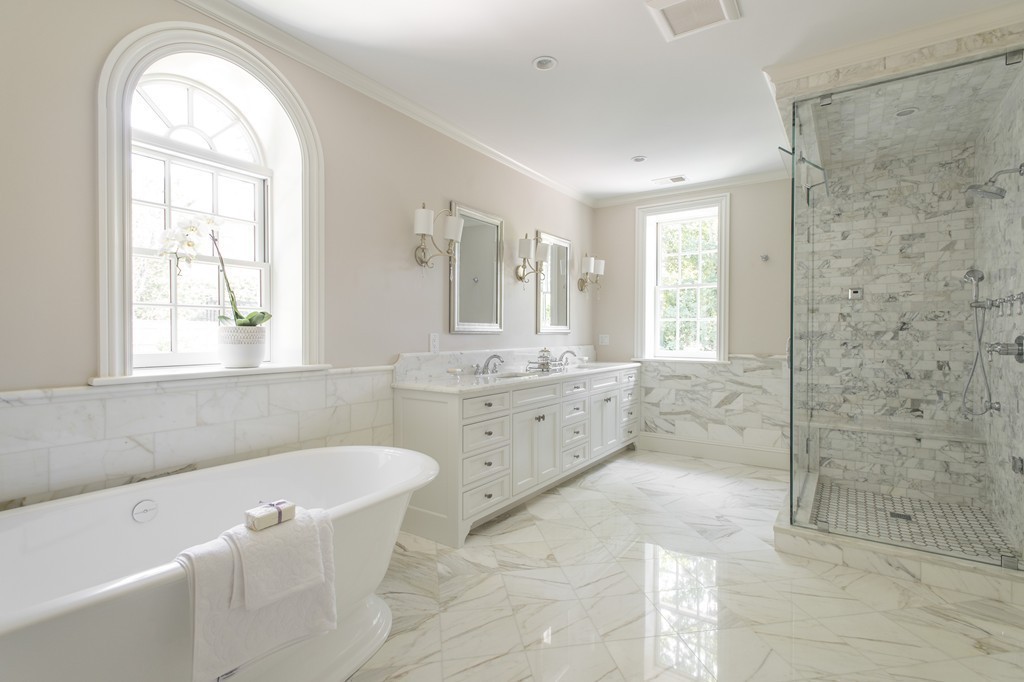 201 Hyslop Road Brookline, MA 02445 - Photo 26 of 30 a bathroom with a granite countertop sink a mirror a bathtub and next to a window