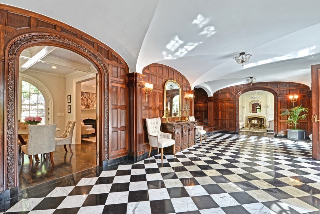 201 Hyslop Road Brookline, MA 02445 - Photo 6 of 30 a living room with a black white checkered floor with a gaming machine and dining chair
