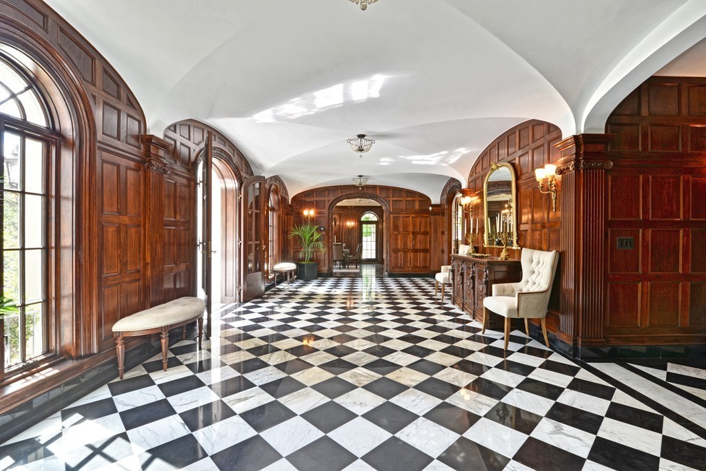 201 Hyslop Road Brookline, MA 02445 - Photo 7 of 30 a living room with a black white checkered floor with a dining table and chair