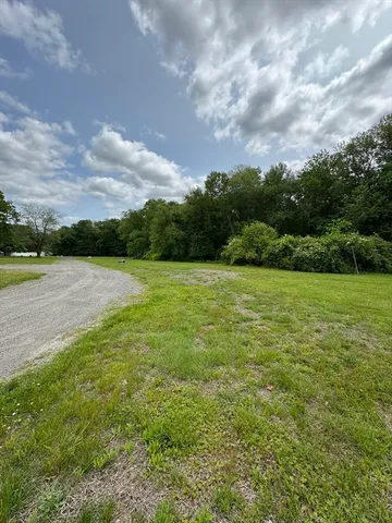 a view of a lake view with houses in the back