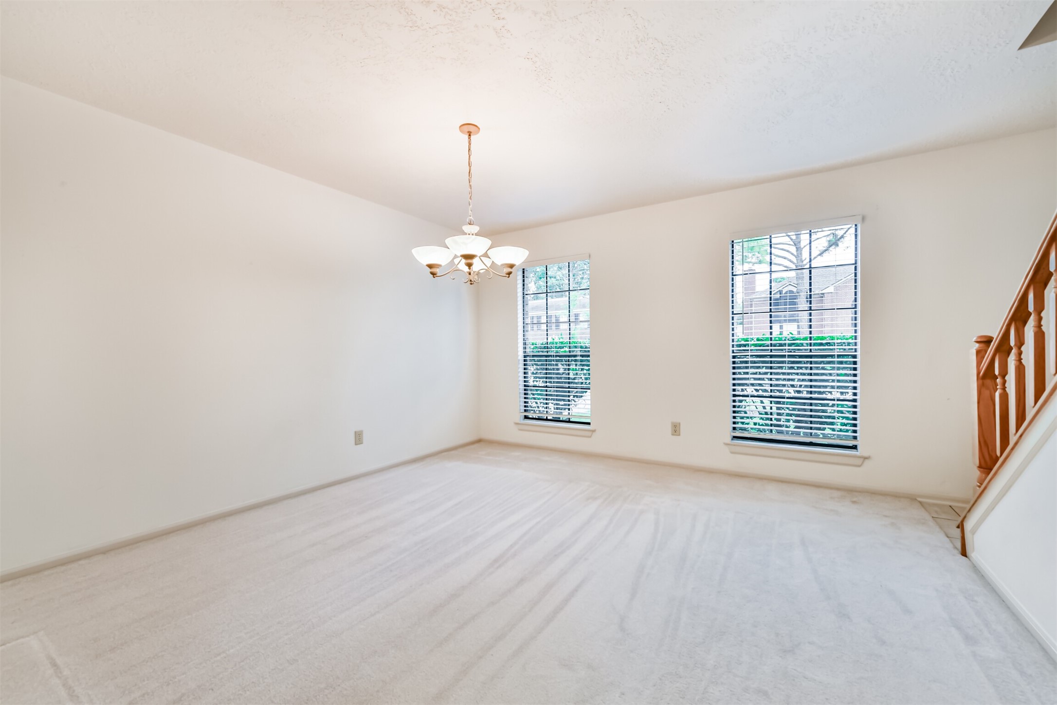 14506 Harvest Ridge Road Houston, TX 77062 - Photo 12 of 39 an empty room with chandelier fan and windows