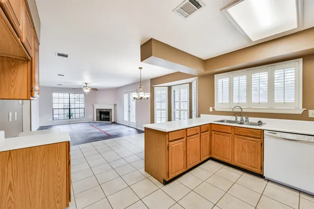 a large kitchen with kitchen island granite countertop a sink window and cabinets