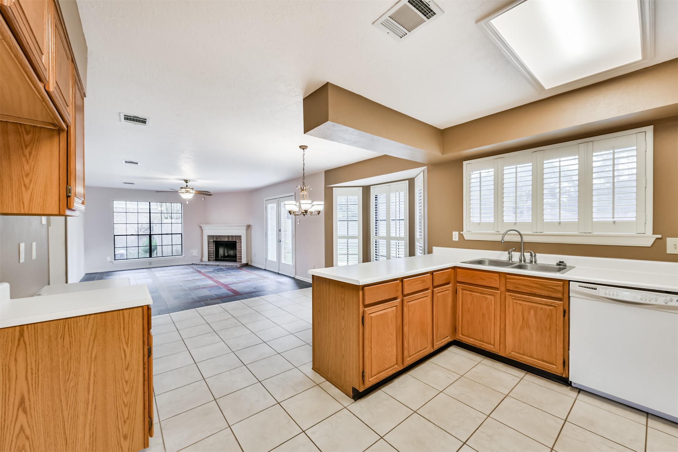 14506 Harvest Ridge Road Houston, TX 77062 - Photo 15 of 39 a large kitchen with kitchen island granite countertop a sink window and cabinets