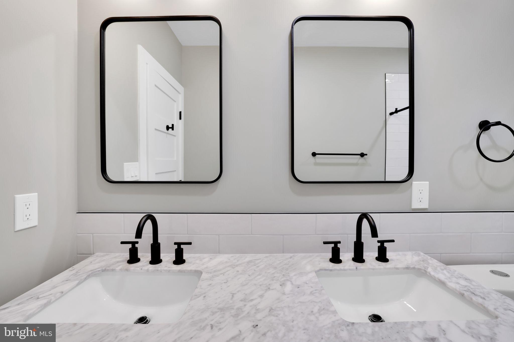 4019 9th Street Northeast, Unit 2 Washington, DC 20017 - Photo 16 of 27 a bathroom with double vanity sinks and a mirror