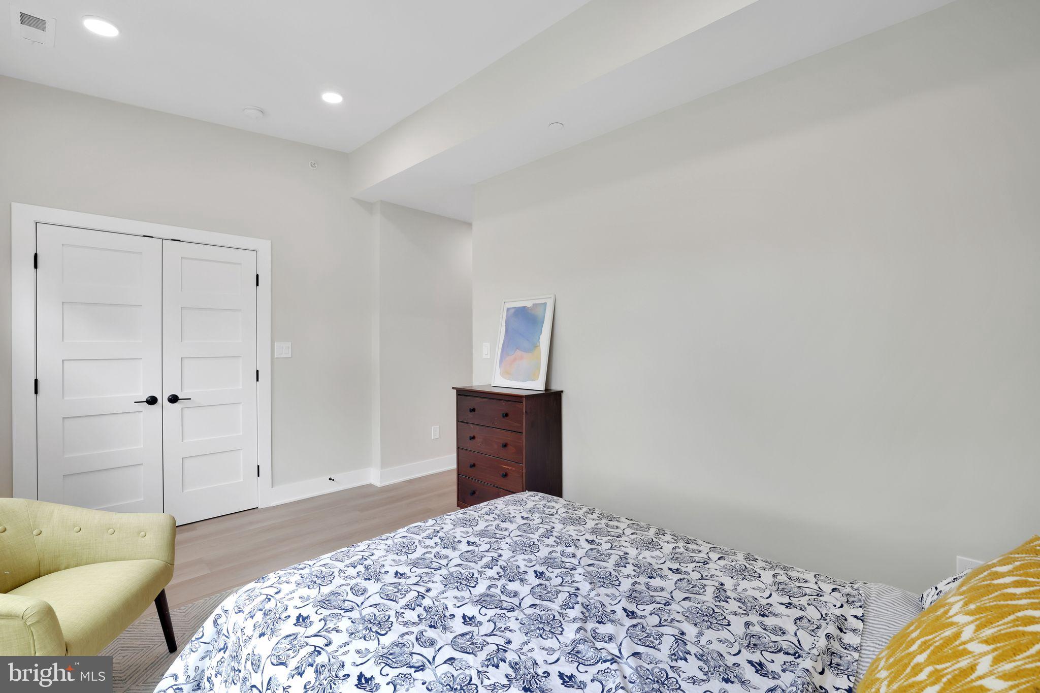4019 9th Street Northeast, Unit 2 Washington, DC 20017 - Photo 20 of 27 a bedroom with a bed and wooden floor