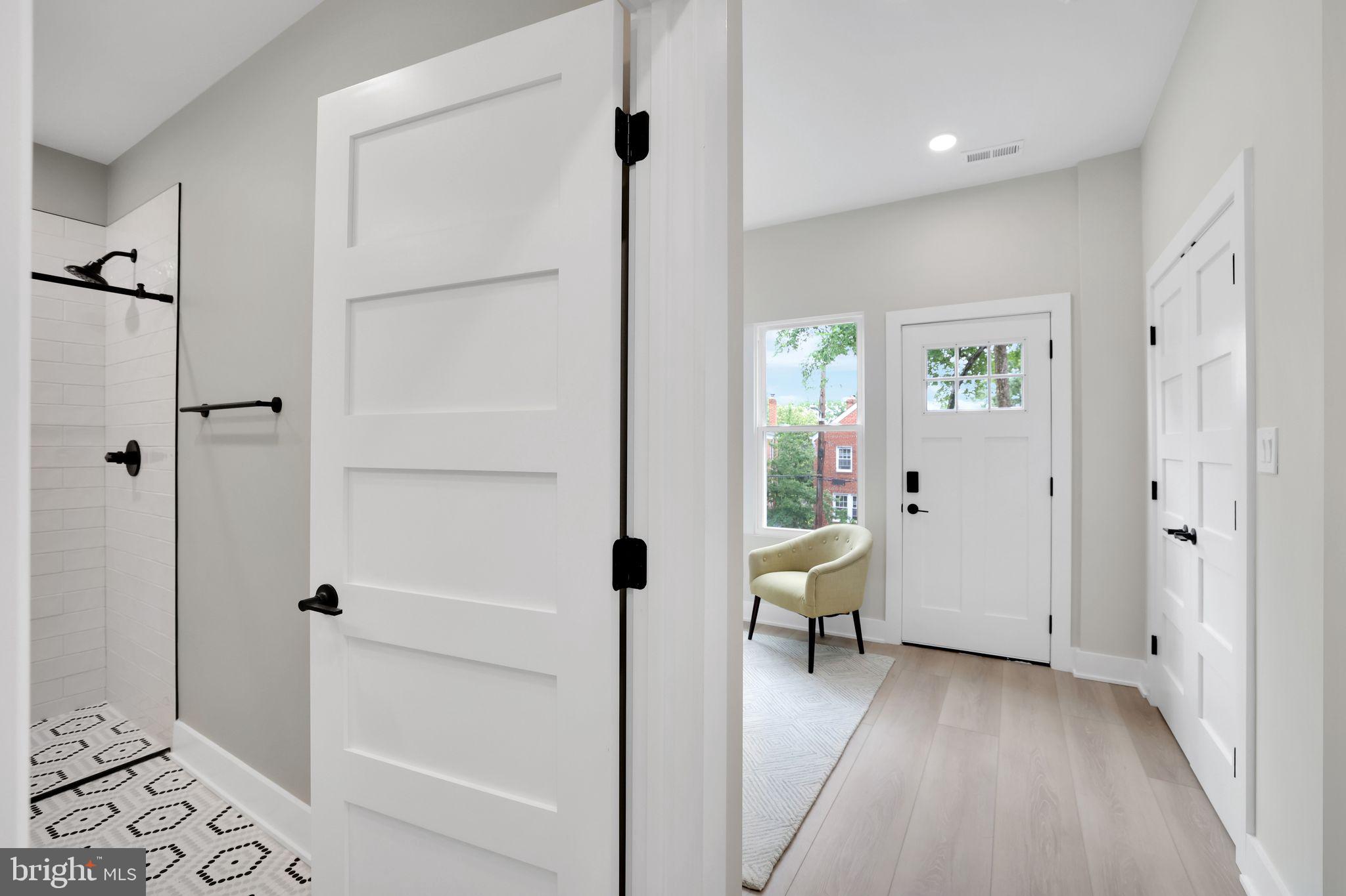 4019 9th Street Northeast, Unit 2 Washington, DC 20017 - Photo 5 of 27 a view of a hallway with bathroom and wooden floor
