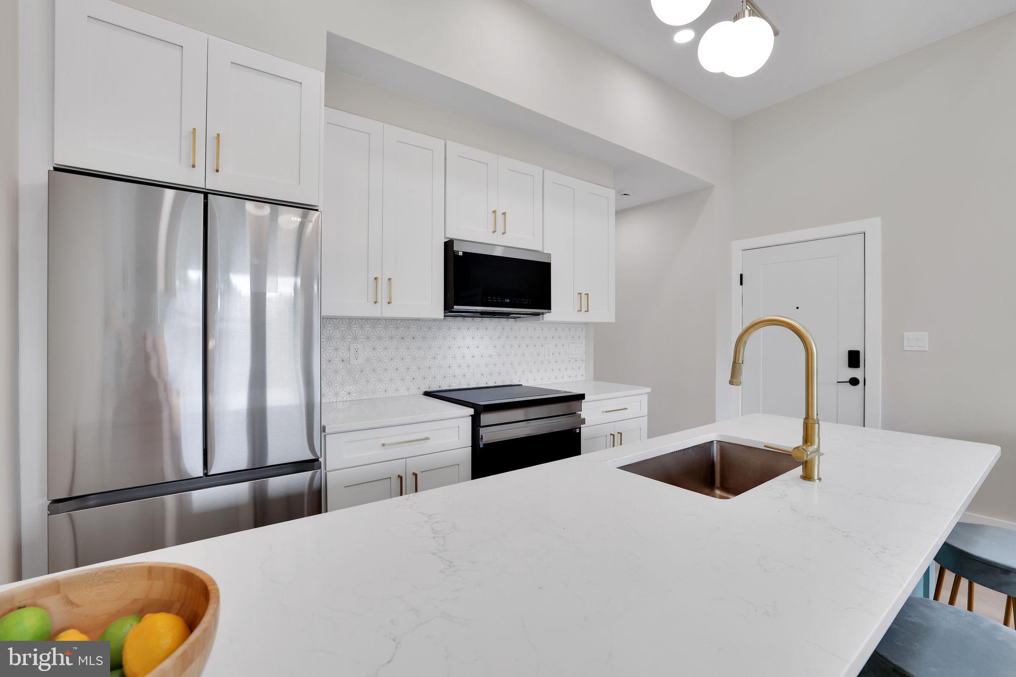 4019 9th Street Northeast, Unit 2 Washington, DC 20017 - Photo 10 of 27 a kitchen with stainless steel appliances a stove refrigerator and a sink