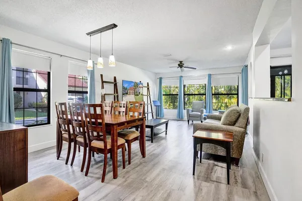 a living room with furniture and a flat screen tv with wooden floor