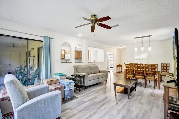 a kitchen with granite countertop a stove a sink a dining table and chairs