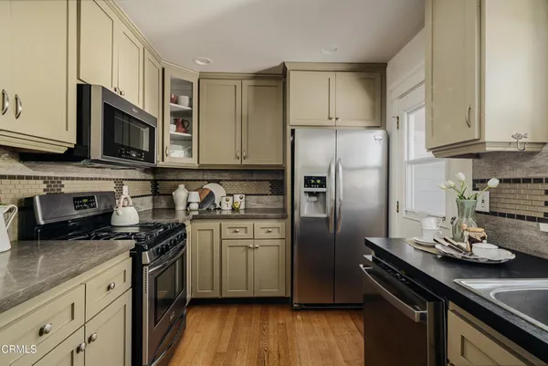 a kitchen with stainless steel appliances and wooden cabinets