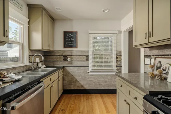 a kitchen with a sink stove and cabinets