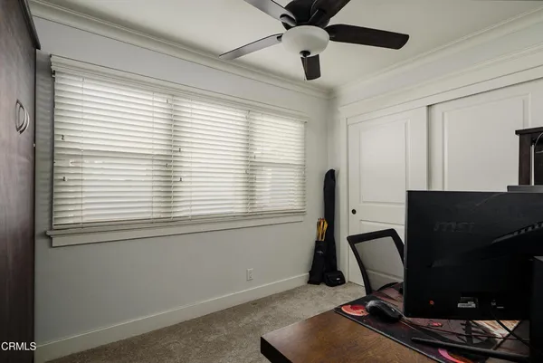 a view of workspace with windows and ceiling fan