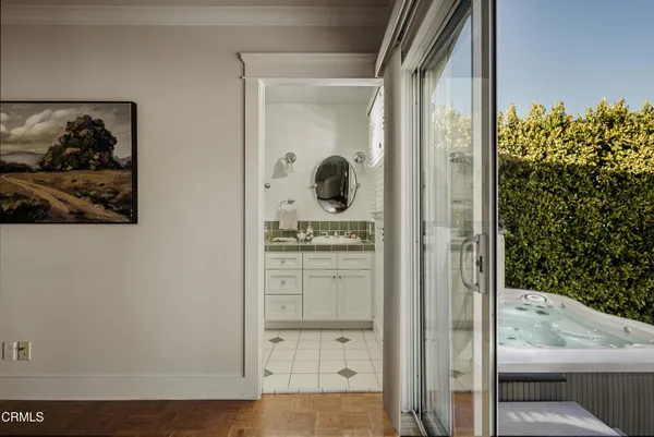 a bathroom with a glass door shower and a sink