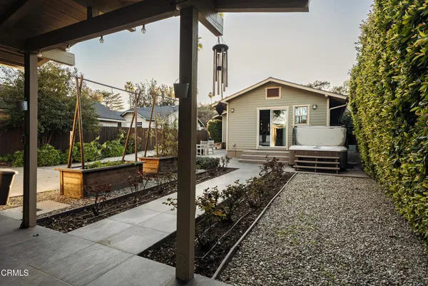 a view of a house with a large window and a tree