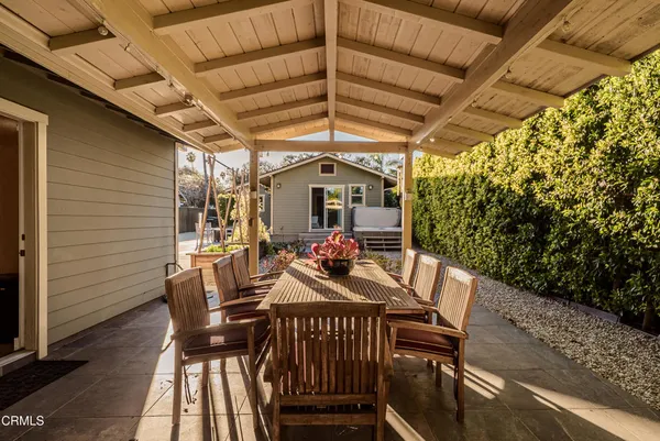 a view of a patio with a table and chairs