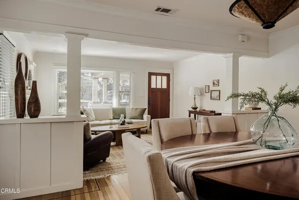 a living room with furniture and large windows
