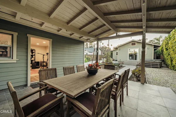a view of a patio with table and chairs with wooden floor