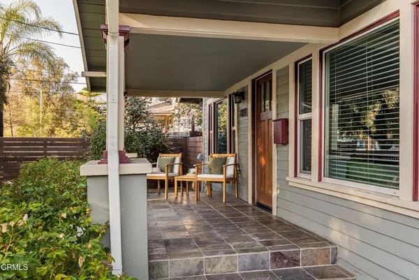 a view of a patio with table and chairs and potted plants
