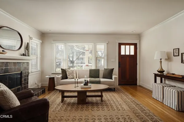 a living room with furniture a fireplace and a table