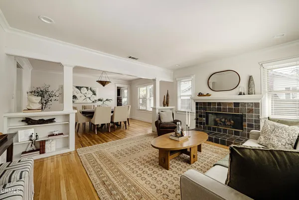 a living room with furniture a fireplace and wooden floor