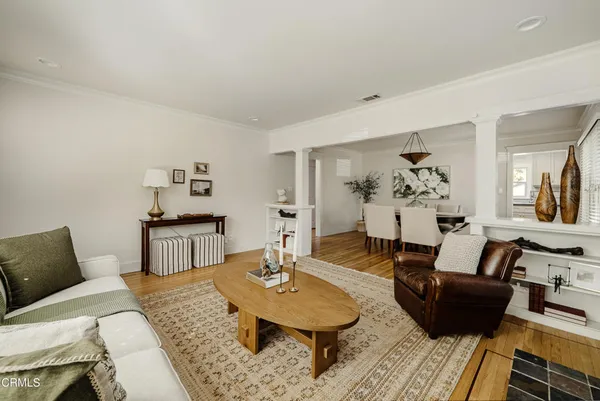 a living room with furniture and wooden floor