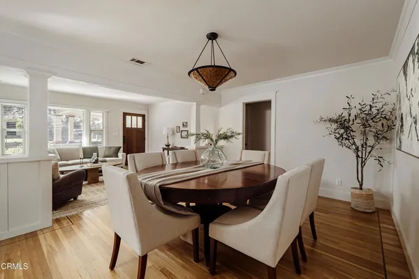 a living room with furniture a potted plant and a chandelier