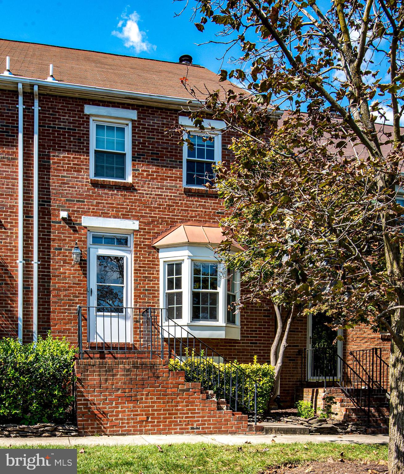 409 Old Town Court Alexandria, VA 22314 - Photo 1 of 32 a front view of a house with garden