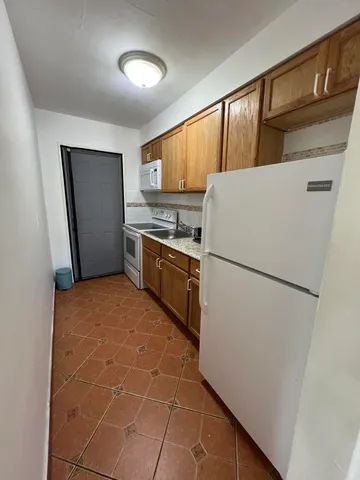 a kitchen with stainless steel appliances a refrigerator sink and cabinets