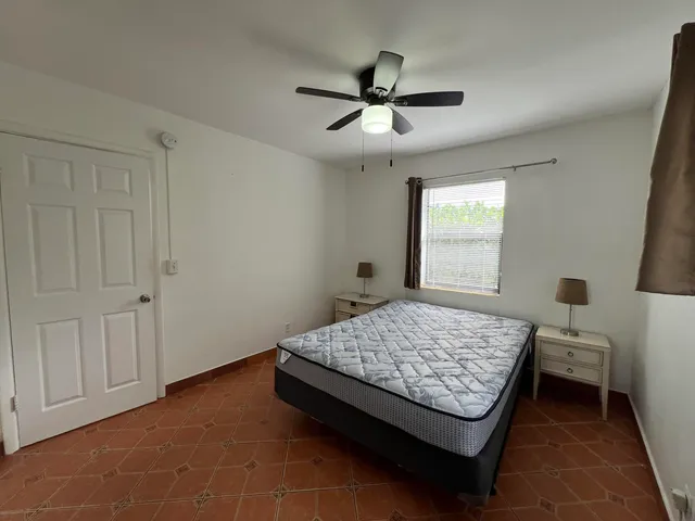 a bedroom with a bed and window