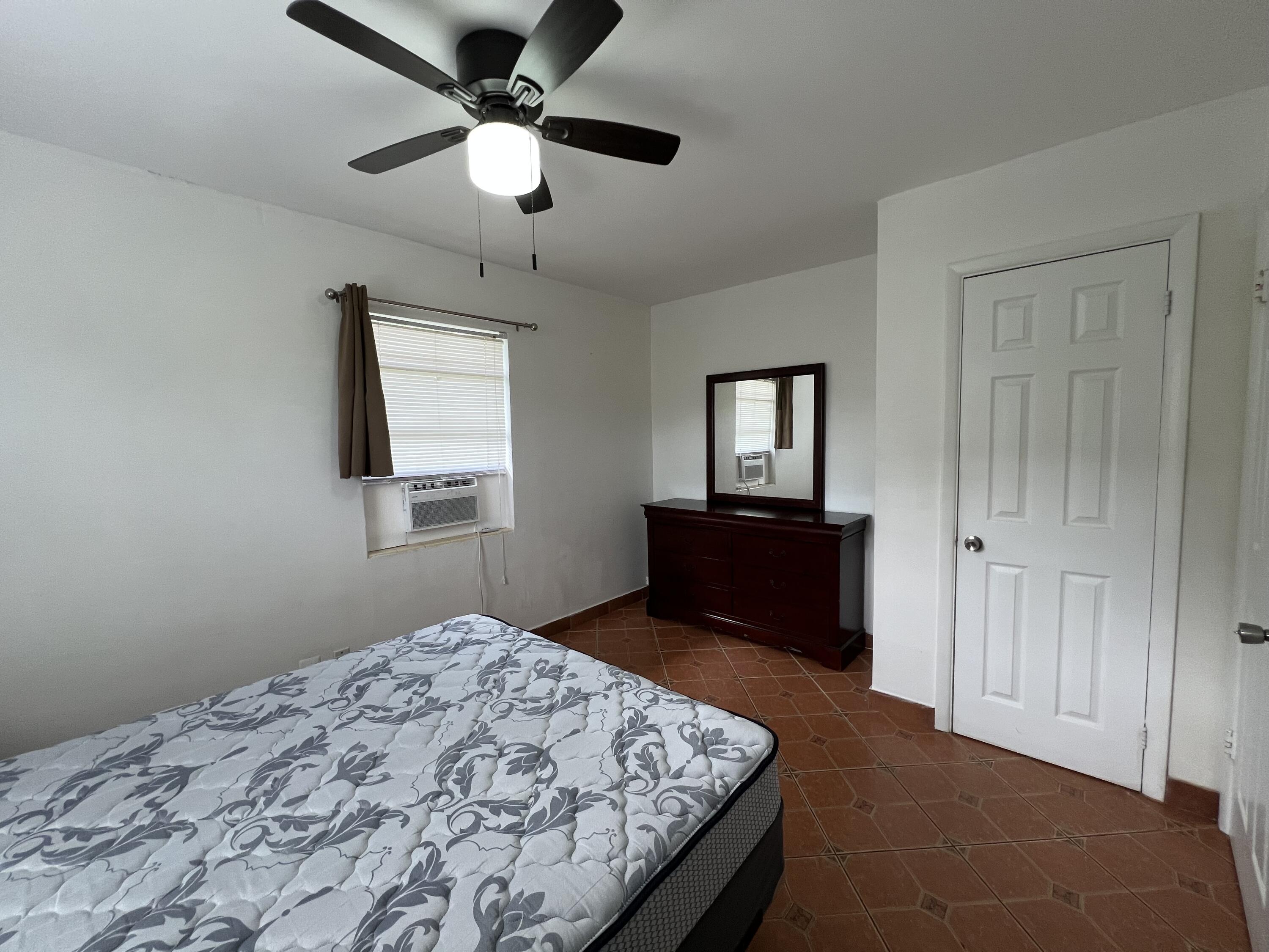 311 Inlet Way, Unit 11 Palm Beach Shores, FL 33404 - Photo 15 of 21 a bedroom with a bed and a dresser