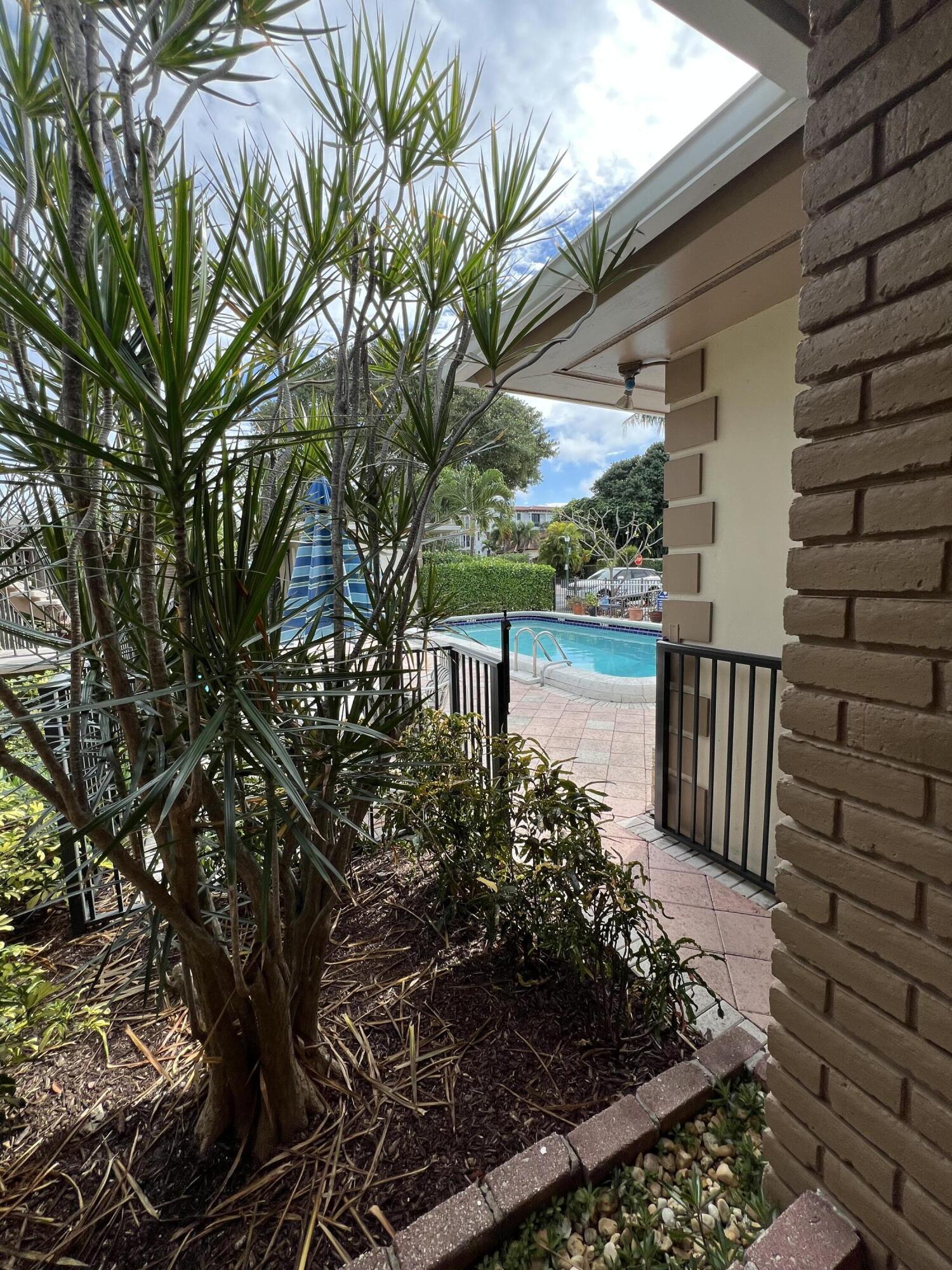 311 Inlet Way, Unit 11 Palm Beach Shores, FL 33404 - Photo 21 of 21 a view of a backyard with plants and a patio