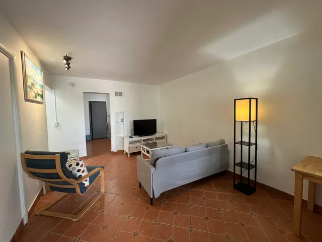 a living room with furniture and a flat screen tv