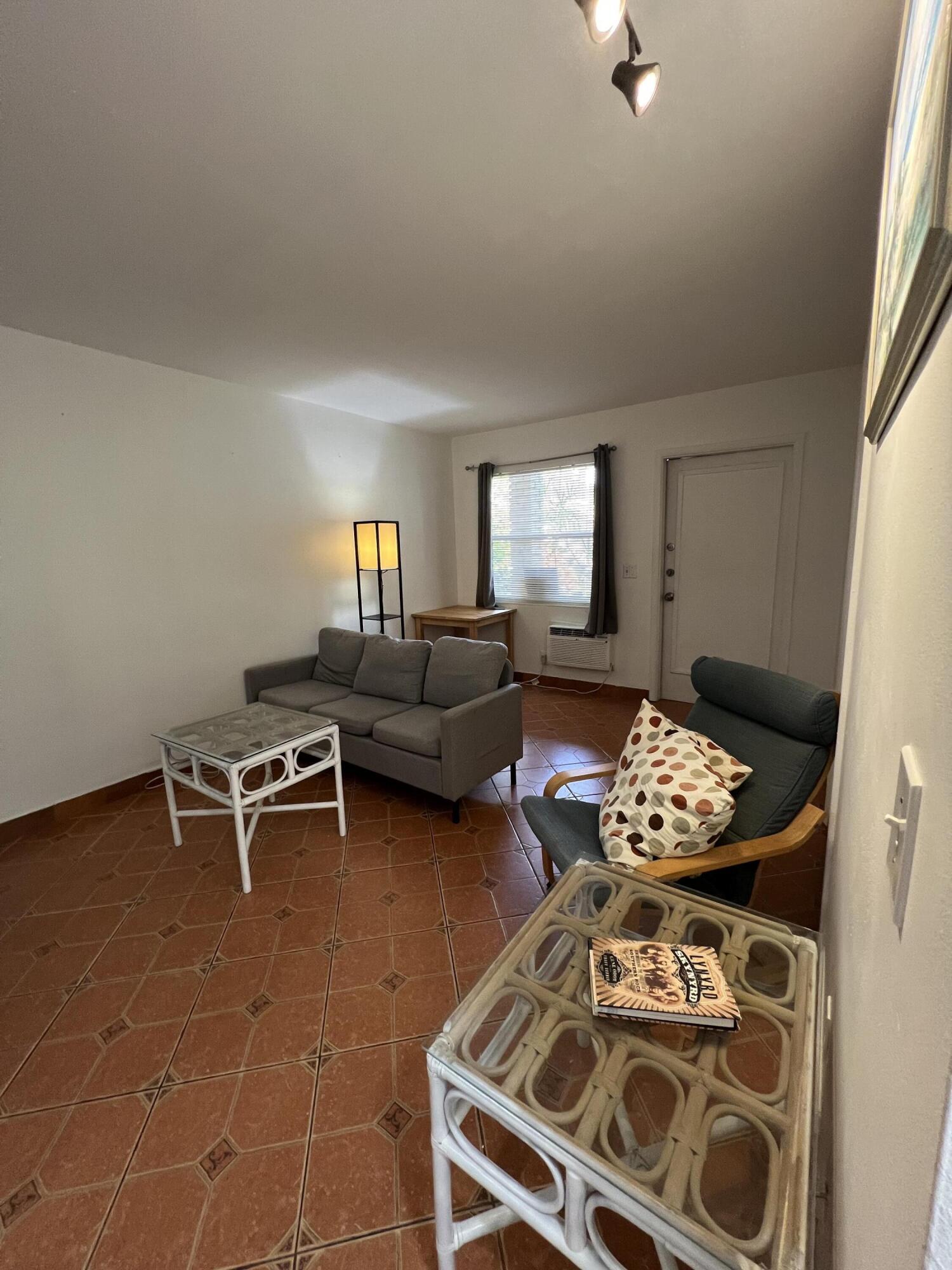 311 Inlet Way, Unit 11 Palm Beach Shores, FL 33404 - Photo 5 of 21 a living room with furniture and wooden floor