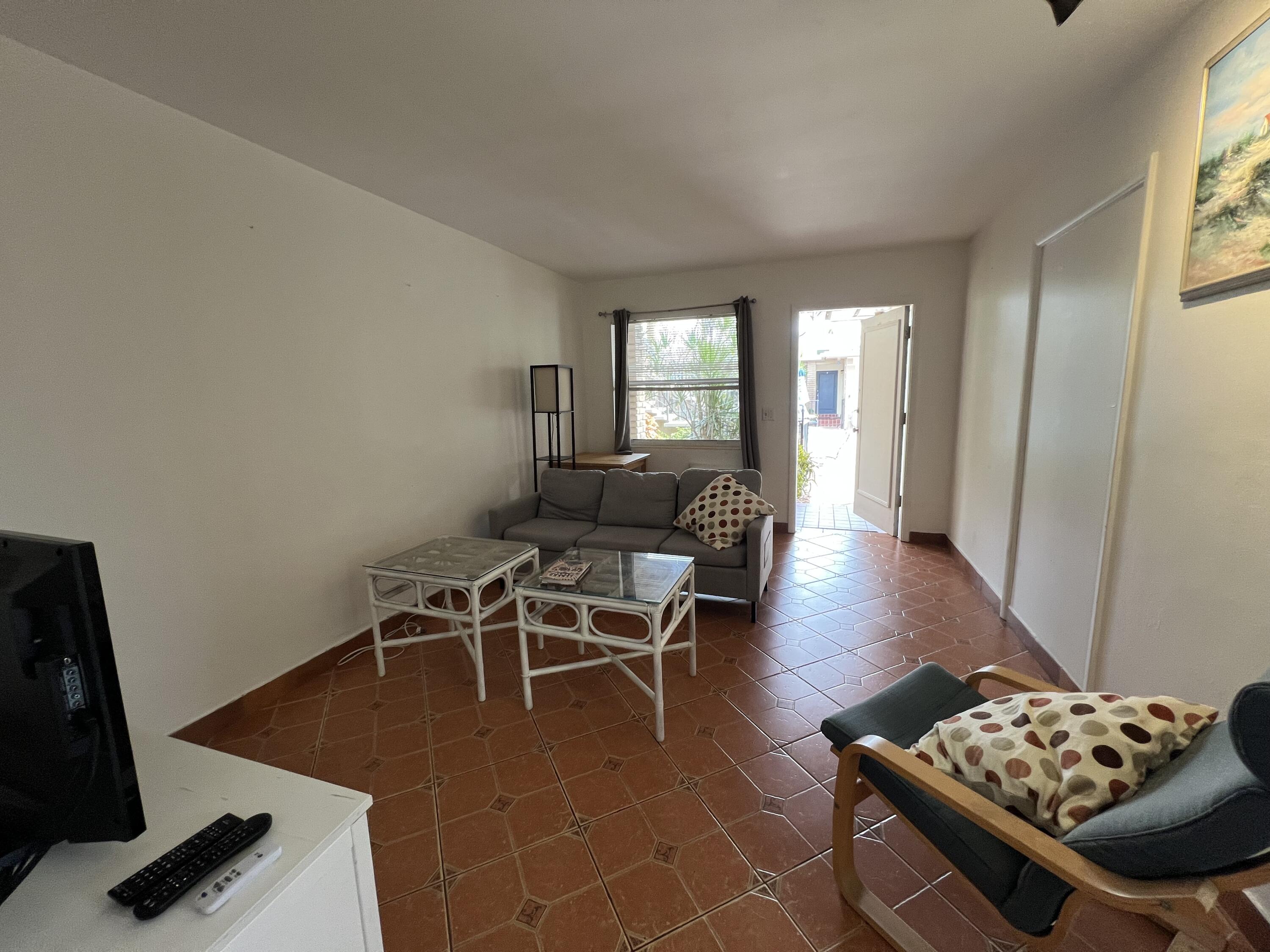 311 Inlet Way, Unit 11 Palm Beach Shores, FL 33404 - Photo 8 of 21 a living room with furniture and a window