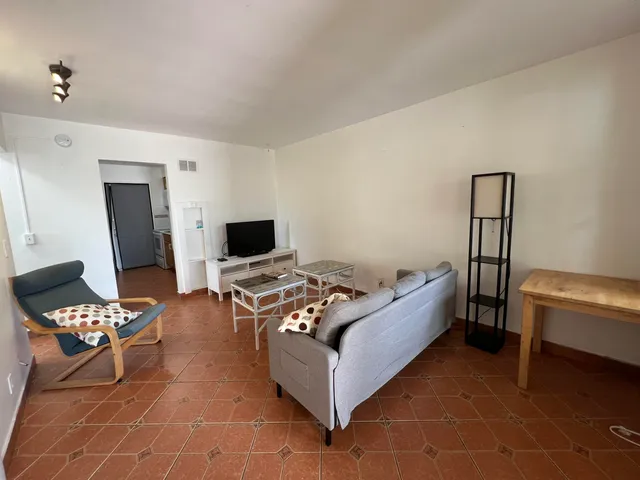 a bed room with a bed and a chair