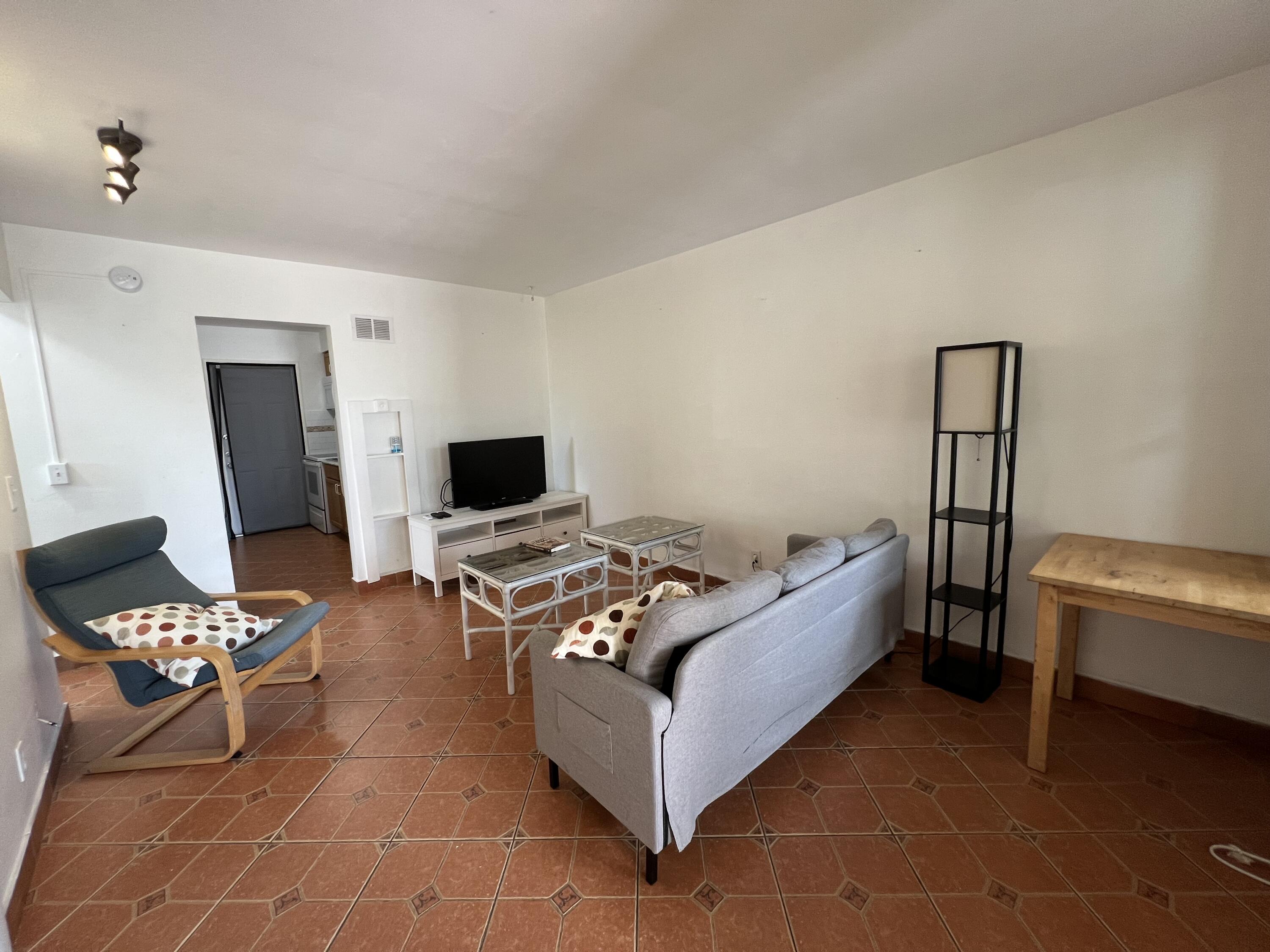 311 Inlet Way, Unit 11 Palm Beach Shores, FL 33404 - Photo 9 of 21 a bed room with a bed and a chair