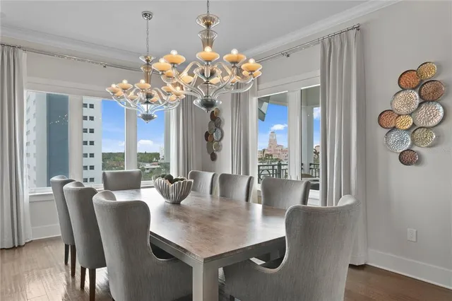 a view of a dining room with furniture and a chandelier
