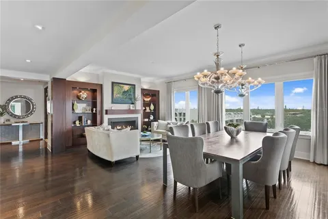 a view of a dining room with furniture and a chandelier