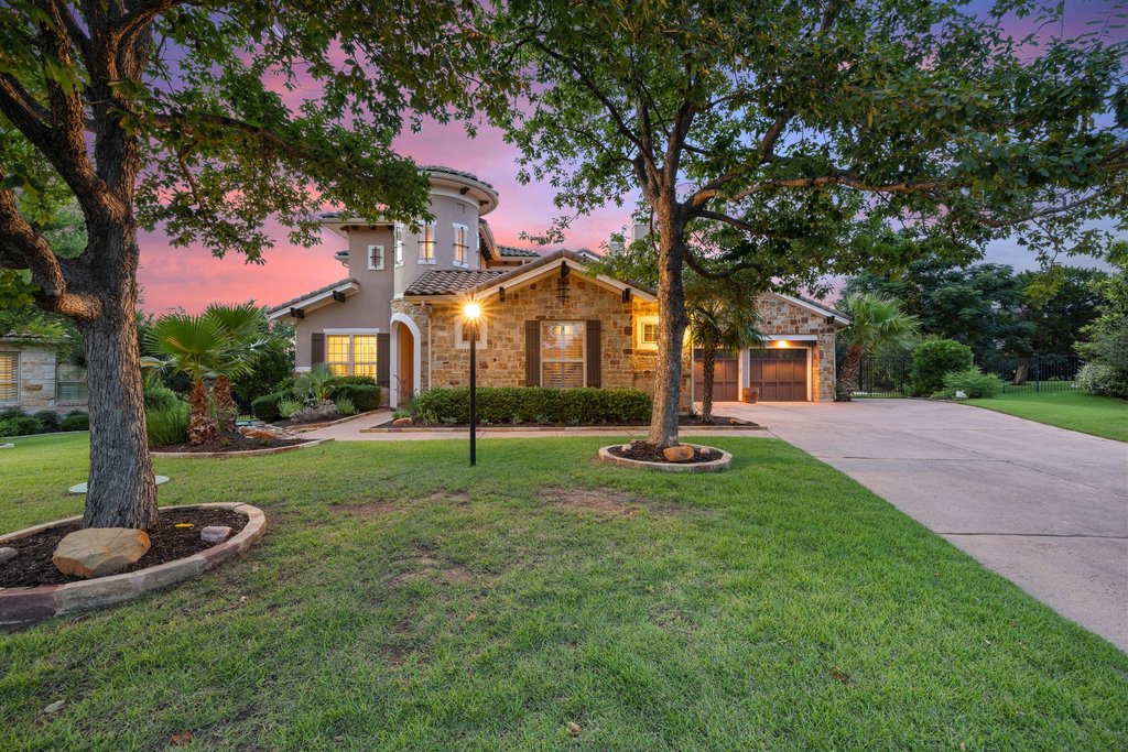 109 Largo Cove Austin, TX 78734 - Photo 1 of 40 Stone and stucco create an impressive façade for this welcoming home, bathed in the soft glow of twilight.