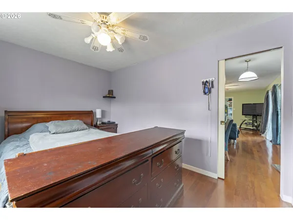 a view of a room that has a bed and a chandelier