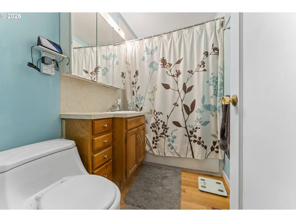 a bathroom with a toilet and a shower curtain