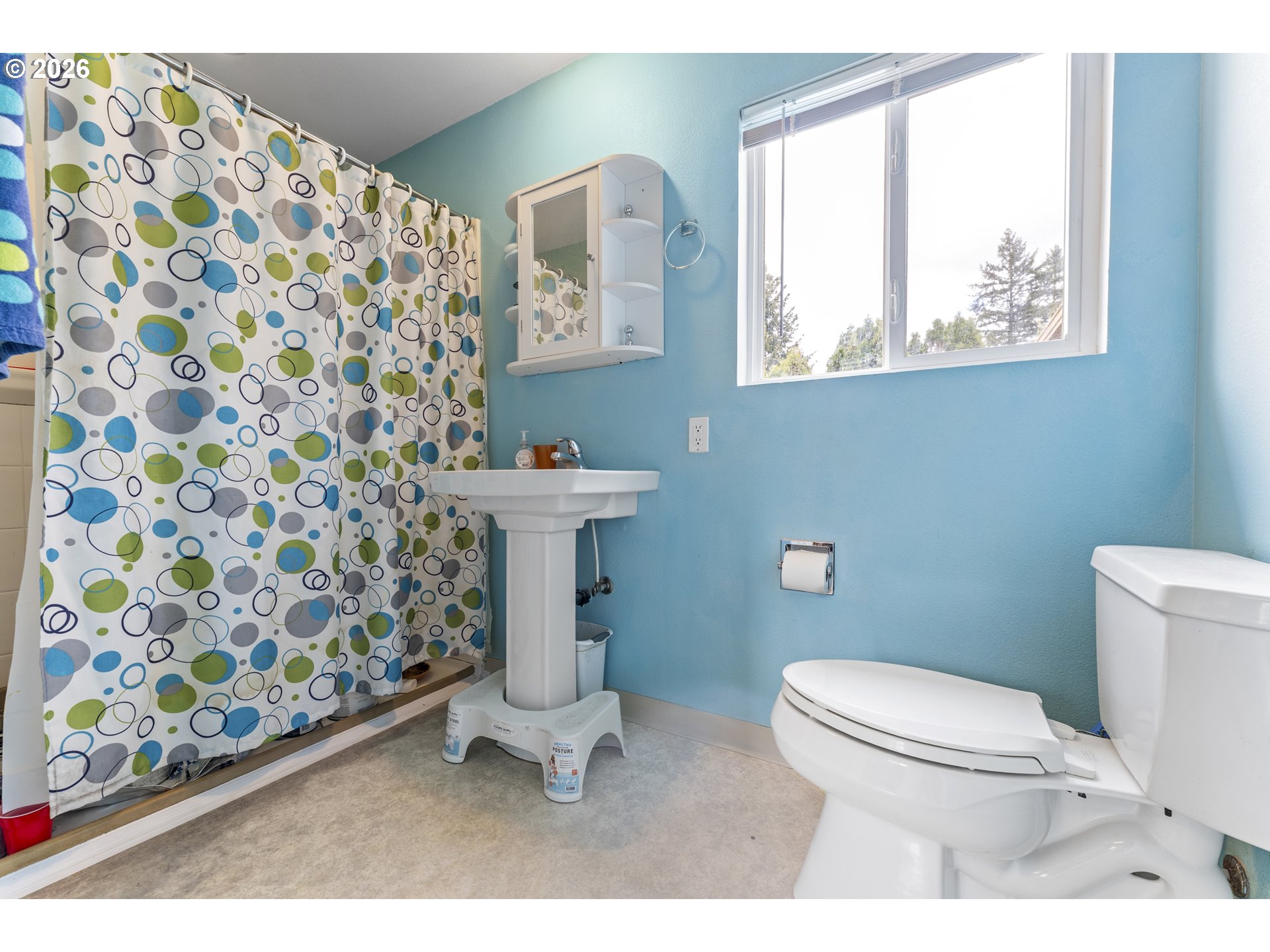 18335 Northeast Flanders Street Portland, OR 97230 - Photo 15 of 20 a white toilet sitting next to a shower curtain