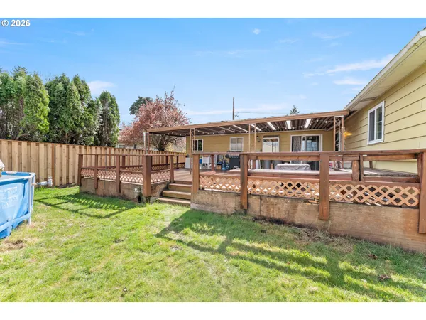 a view of a backyard with a garden and deck