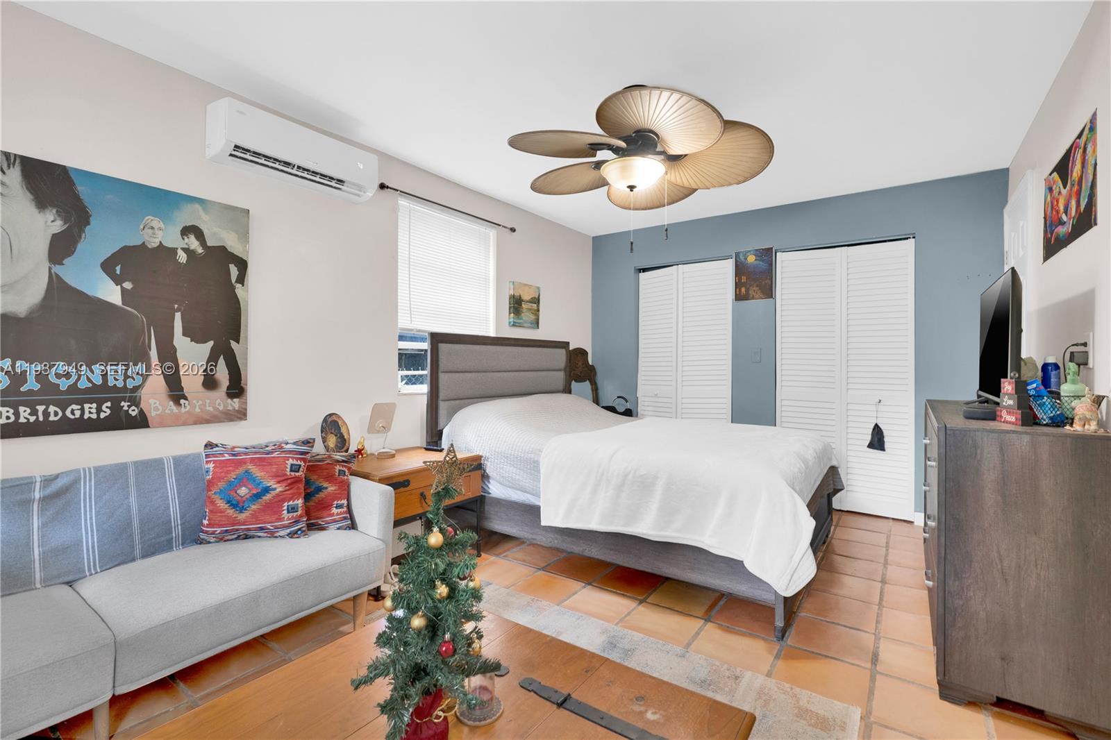 4739 Southwest 5th Street Miami, FL 33134 - Photo 17 of 40 a spacious bedroom with a bed and a chandelier