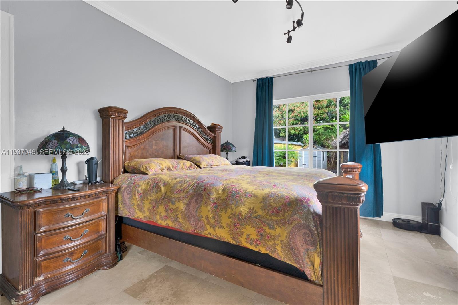 4739 Southwest 5th Street Miami, FL 33134 - Photo 35 of 40 a bedroom with a large bed and a flat tv screen on dresser