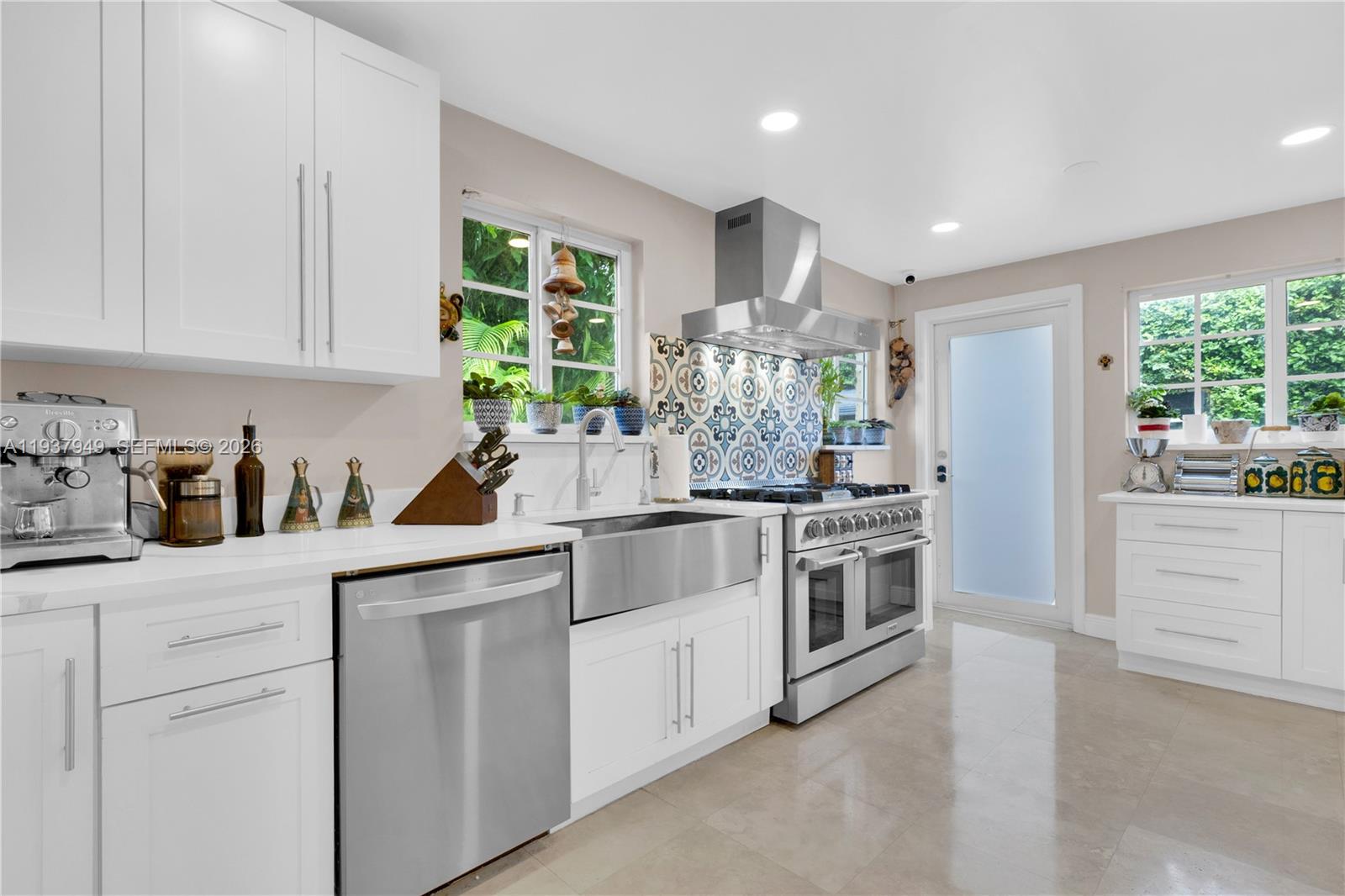 4739 Southwest 5th Street Miami, FL 33134 - Photo 4 of 40 a kitchen with white cabinets and white appliances