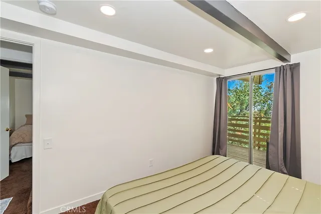 a room with pool table flat screen tv and windows