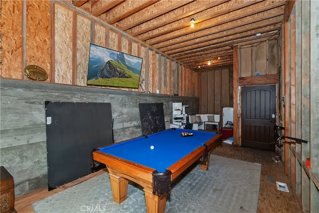 a room with pool table and windows